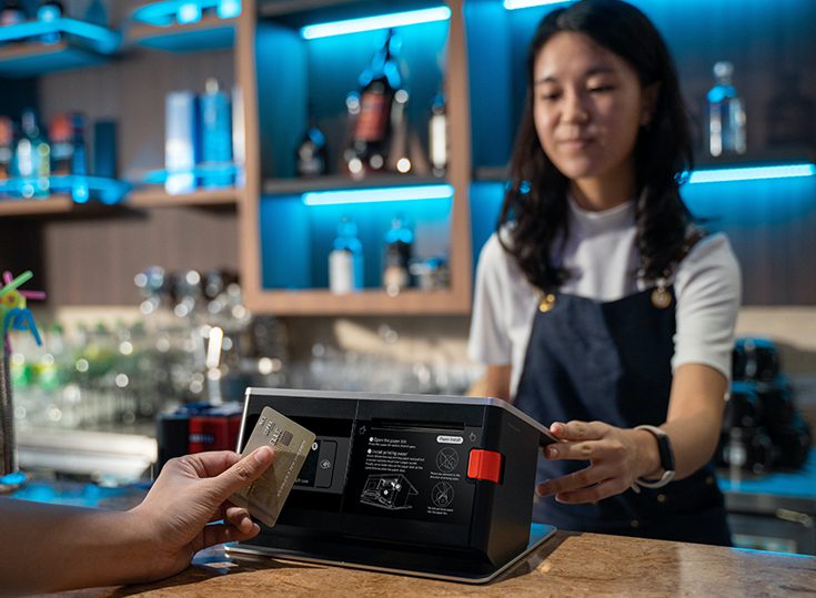 A woman is paying for something at the counter.