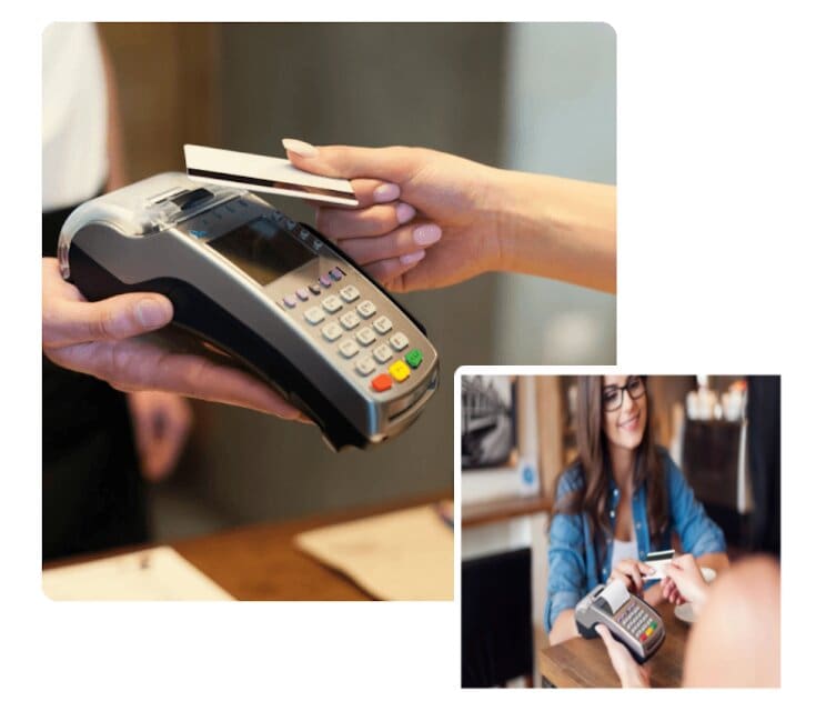 A person holding a credit card while using a machine.